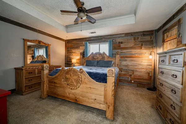 a bedroom with furniture and a flat screen tv