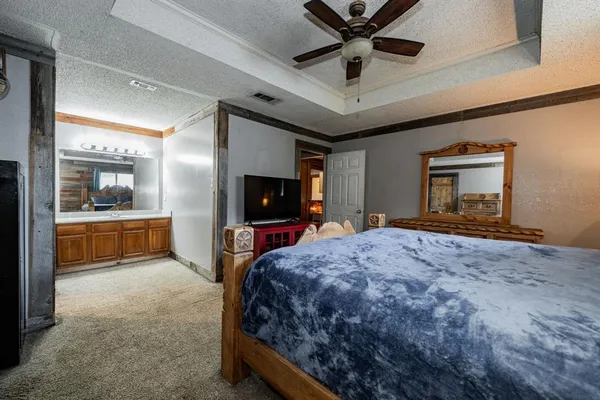 a bathroom with a granite countertop sink mirror and a toilet