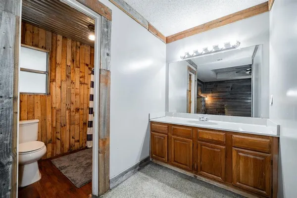 a white toilet sitting next to a shower curtain