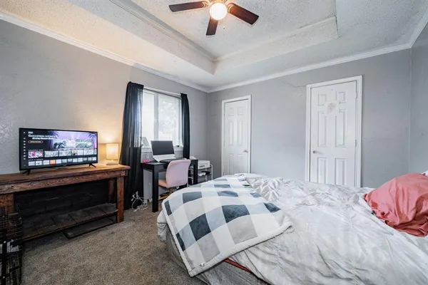 a bedroom with a bed and a book shelf