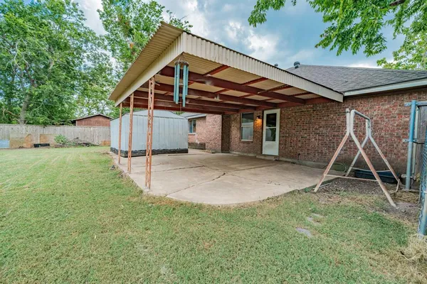 a view of a house with a yard and sitting area