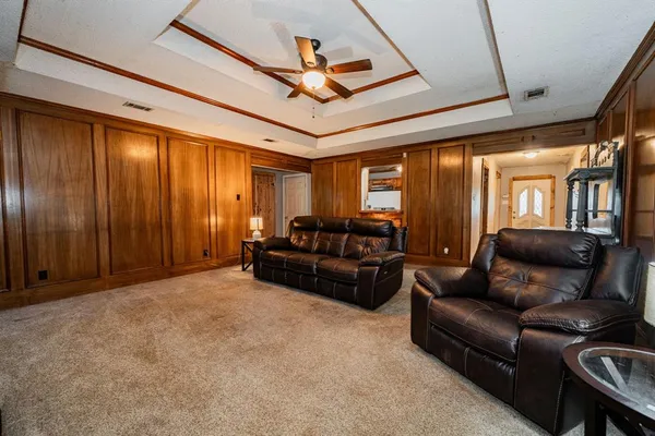 a kitchen with stainless steel appliances granite countertop a refrigerator a stove a sink dishwasher and wooden cabinets with wooden floor