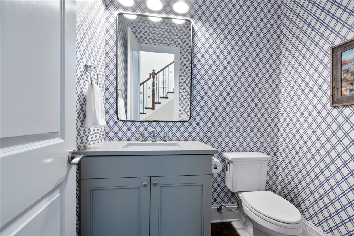 2921 Simpson Street Evanston, IL 60201 - Photo 15 of 41 a bathroom with a toilet sink vanity and mirror