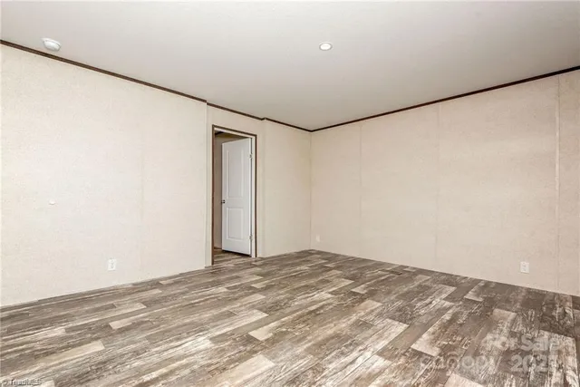 a view of a room with a wooden floor and a window
