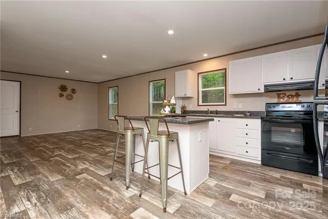 a kitchen with a stove a sink and a refrigerator