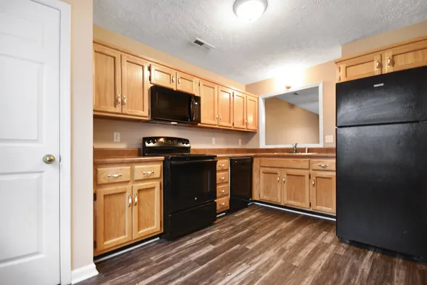 a kitchen with a refrigerator stove and microwave