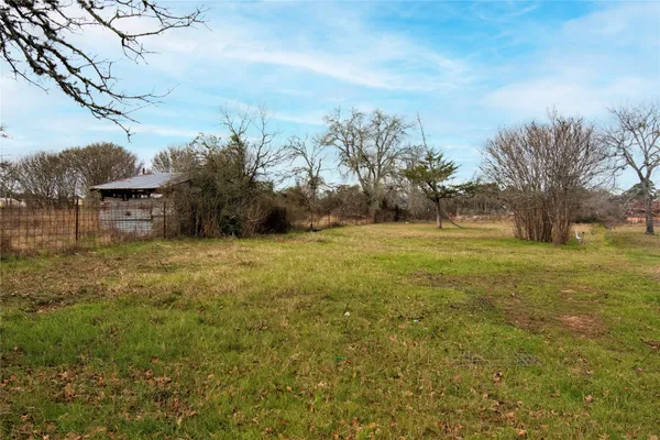 a view of a field with an trees