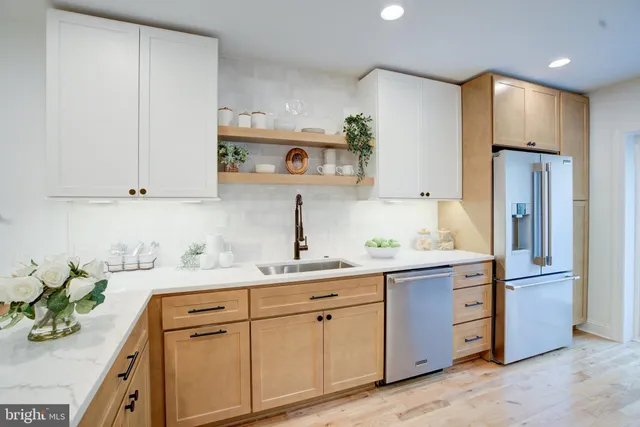 a kitchen with a sink stainless steel appliances and cabinets