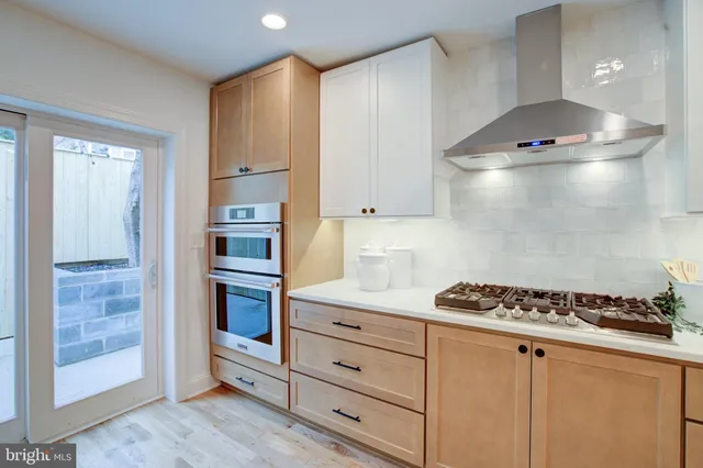 a kitchen with cabinets and appliances
