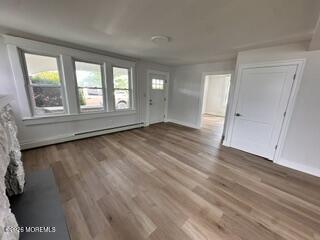 1721 River Road Belmar, NJ 07719 - Photo 2 of 14 an empty room with wooden floor and windows