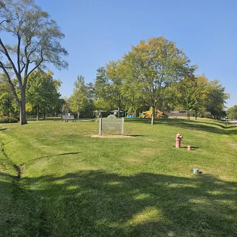a view of a park with large trees
