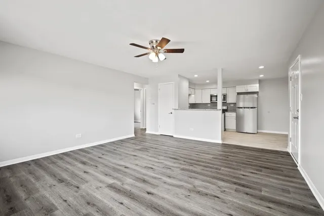 a view of a kitchen with wooden floor and a kitchen space