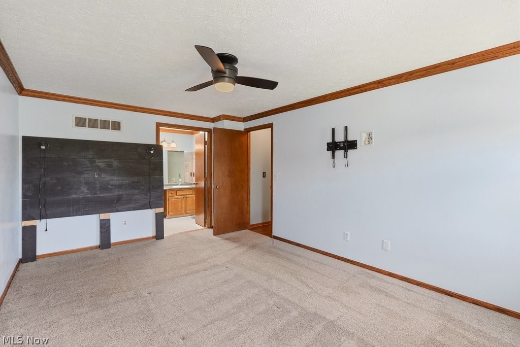 5321 Young Road Stow, OH 44224 - Photo 23 of 37 Carpeted room with a ceiling fan, light blue walls, and wood trim
