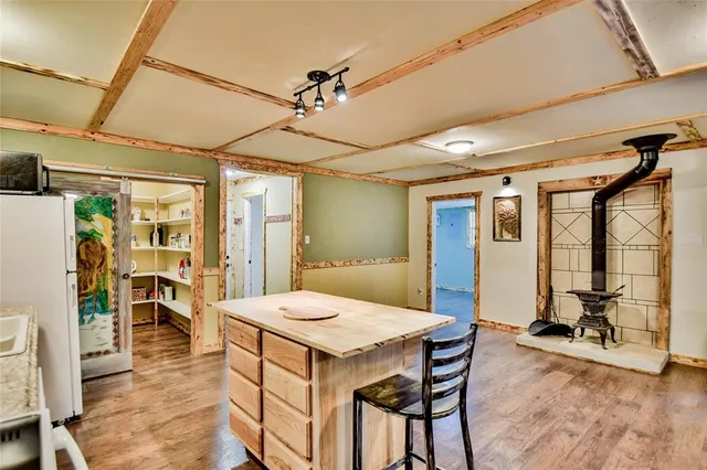 a kitchen that has a stove a table and chairs in it