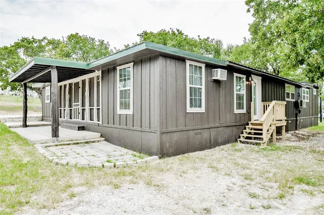 a backyard of a house with wooden fence and roof