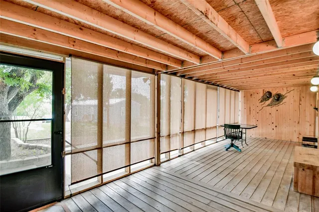 a balcony with wooden floor and furniture