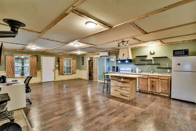 a kitchen with a refrigerator and white cabinets