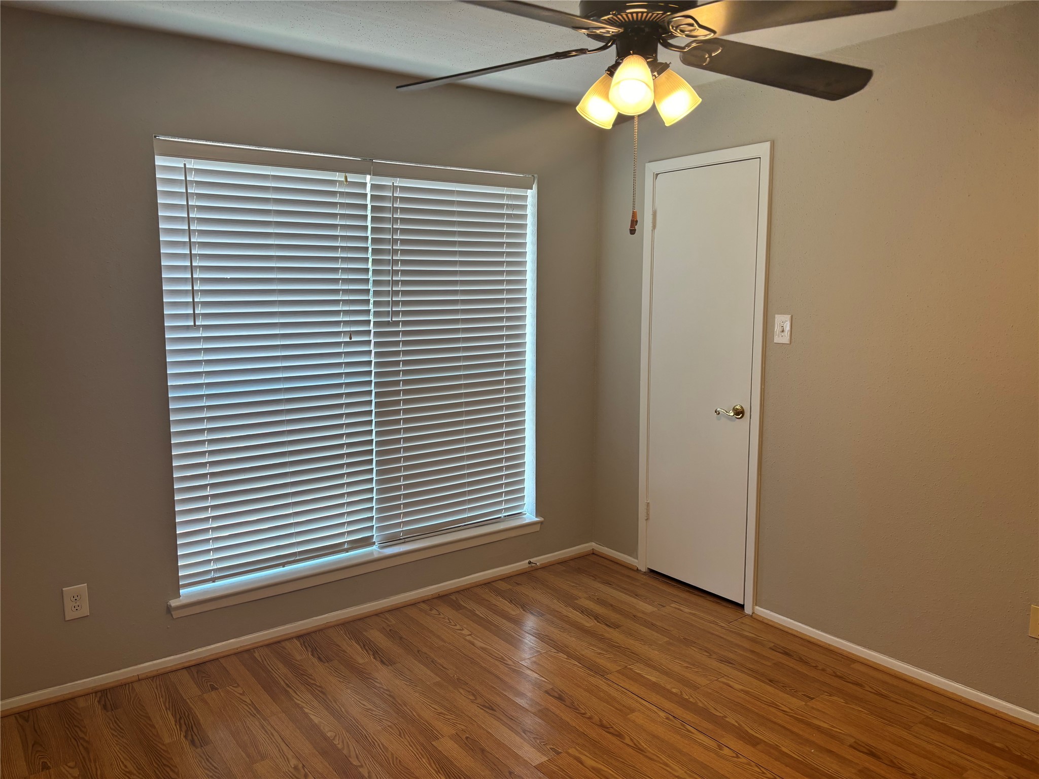 18800 Egret Bay Boulevard, Unit 1100 Webster, TX 77058 - Photo 2 of 7 a view of an empty room with window and wooden floor