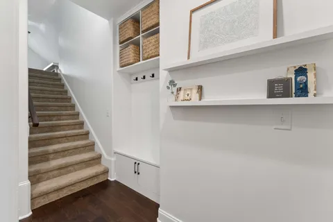 a view of entryway and hall with wooden floor