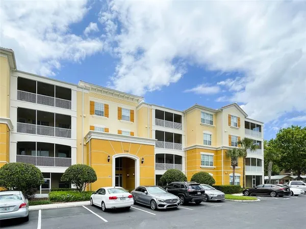 a couple of cars parked in front of a building