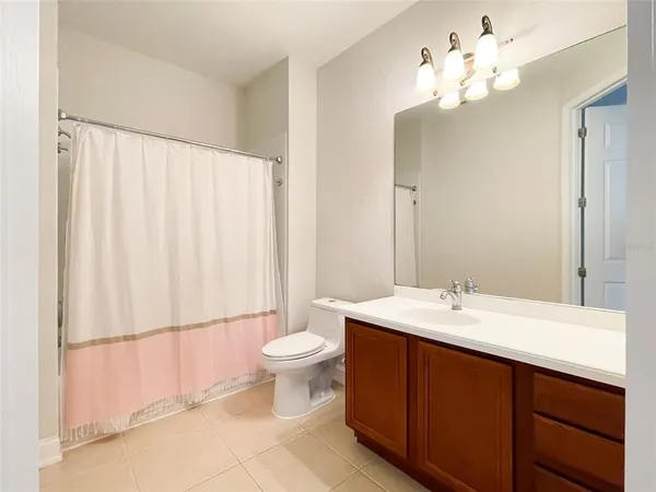 a bathroom with a double vanity sink mirror and toilet