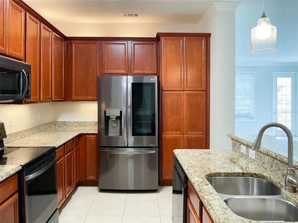 a kitchen with stainless steel appliances granite countertop a refrigerator stove a sink and dishwasher