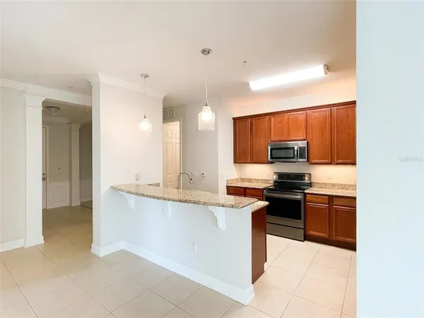 a kitchen with stainless steel appliances a sink and a counter