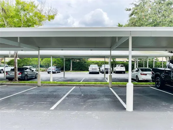 a view of a patio with table and chairs under an umbrella
