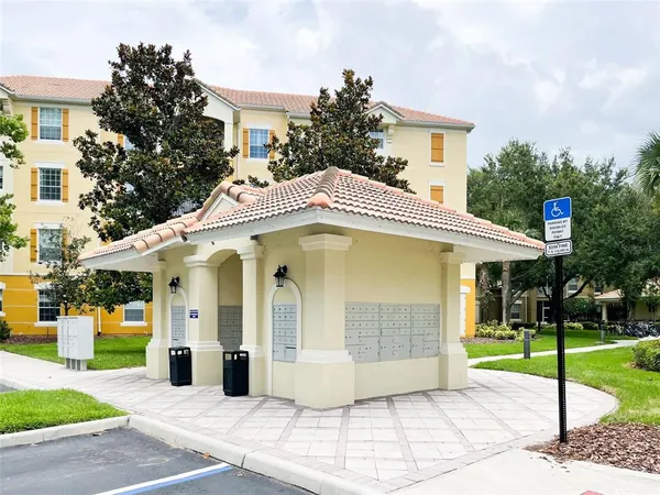 a view of a white house with a yard and plants