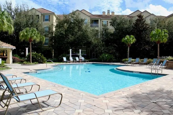 a view of a house with swimming pool and a garden