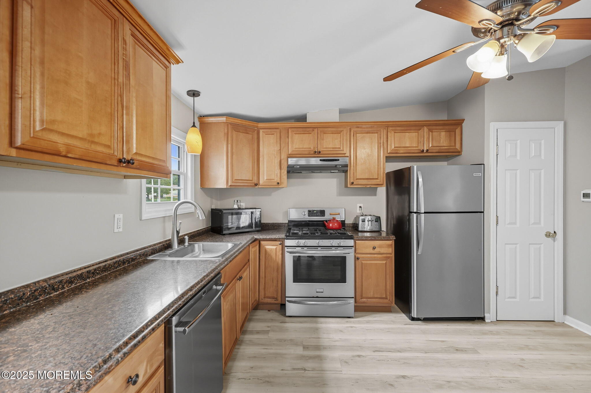 12 Alydar Court Howell, NJ 07731 - Photo 7 of 24 a kitchen with a refrigerator sink and cabinets