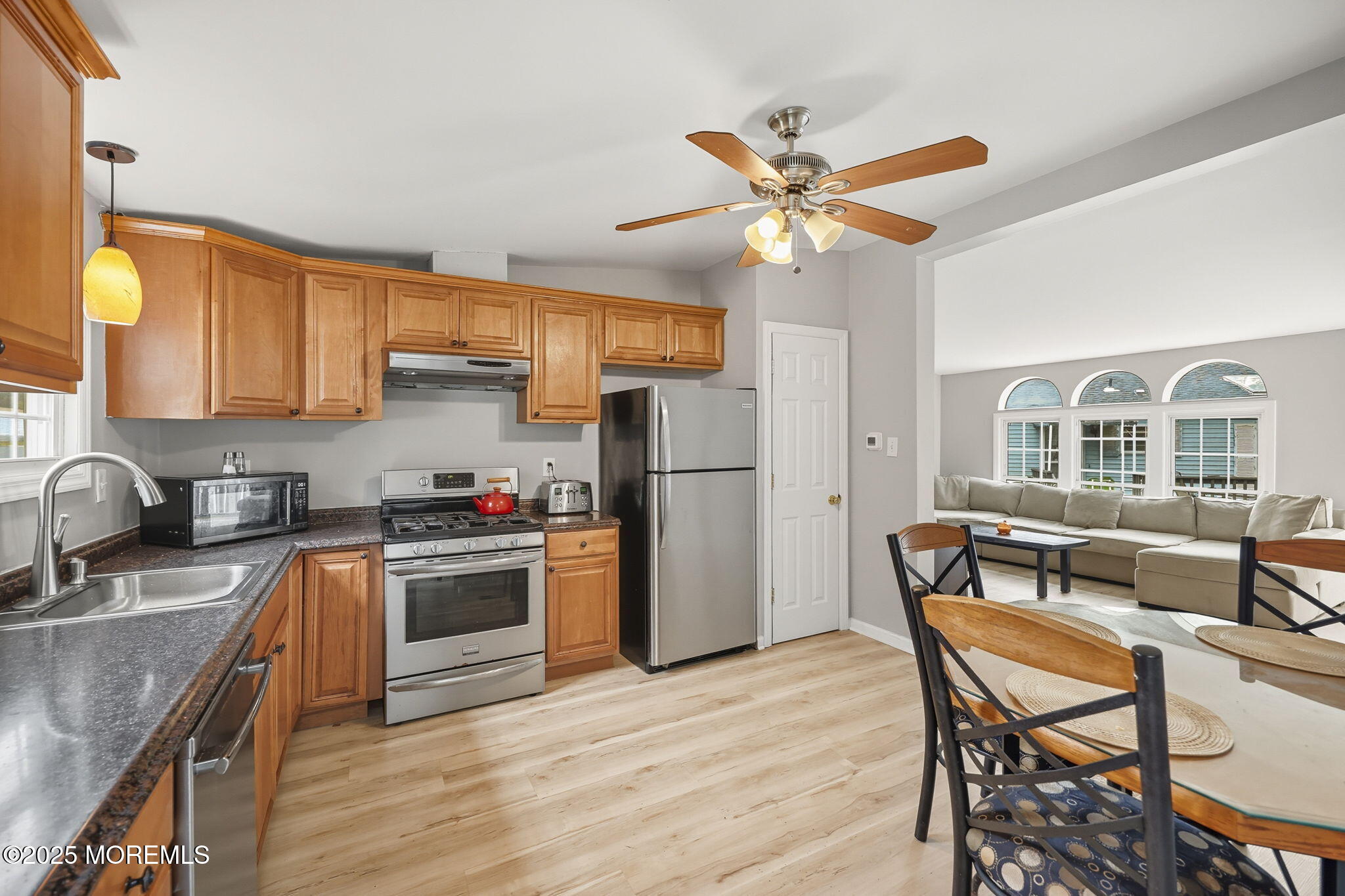 12 Alydar Court Howell, NJ 07731 - Photo 8 of 24 a kitchen with stainless steel appliances granite countertop a dining table chairs refrigerator and sink
