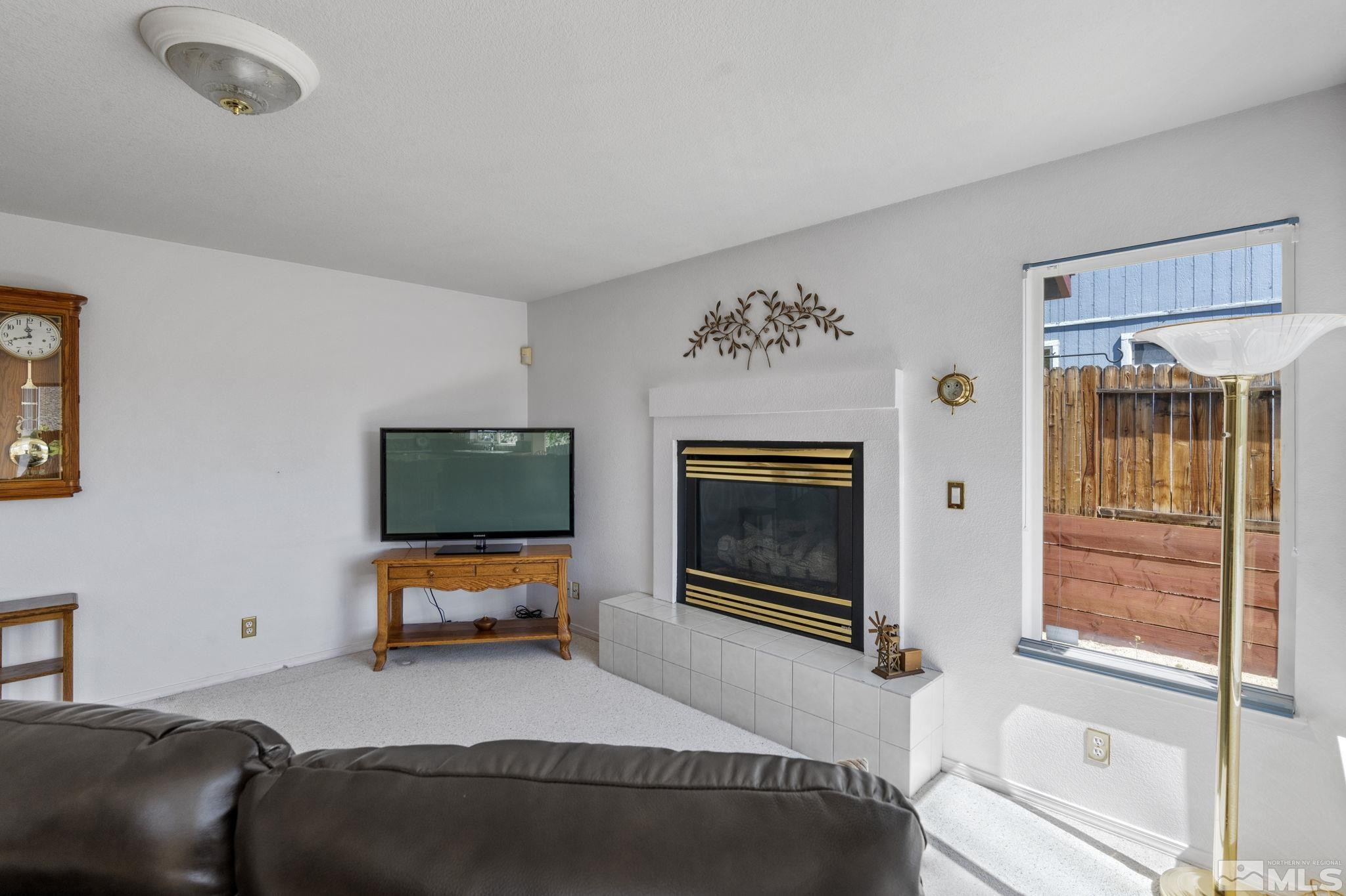 1348 Backer Way Reno, NV 89523 - Photo 12 of 40 a bedroom with furniture and a fireplace