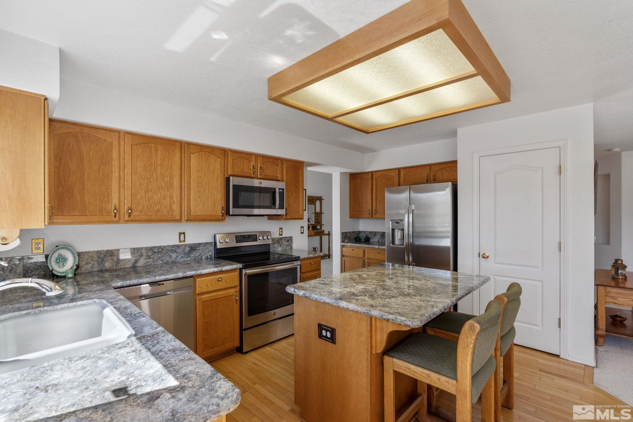 1348 Backer Way Reno, NV 89523 - Photo 14 of 40 a kitchen with a stove a sink and a refrigerator