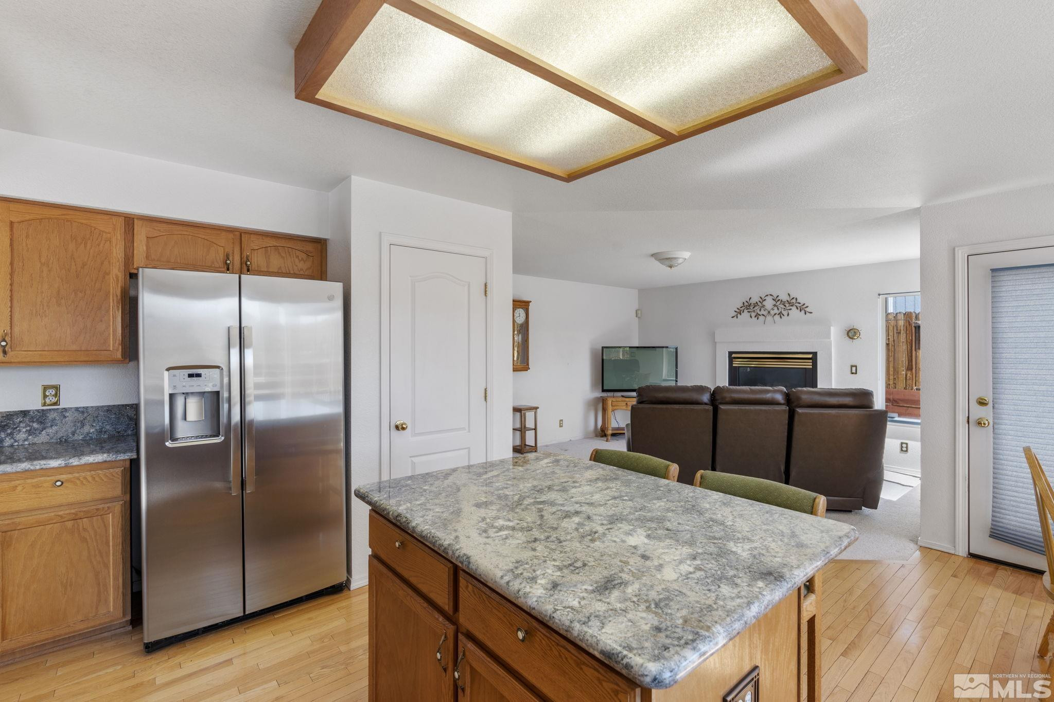 1348 Backer Way Reno, NV 89523 - Photo 16 of 40 a kitchen with stainless steel appliances granite countertop a refrigerator and a sink