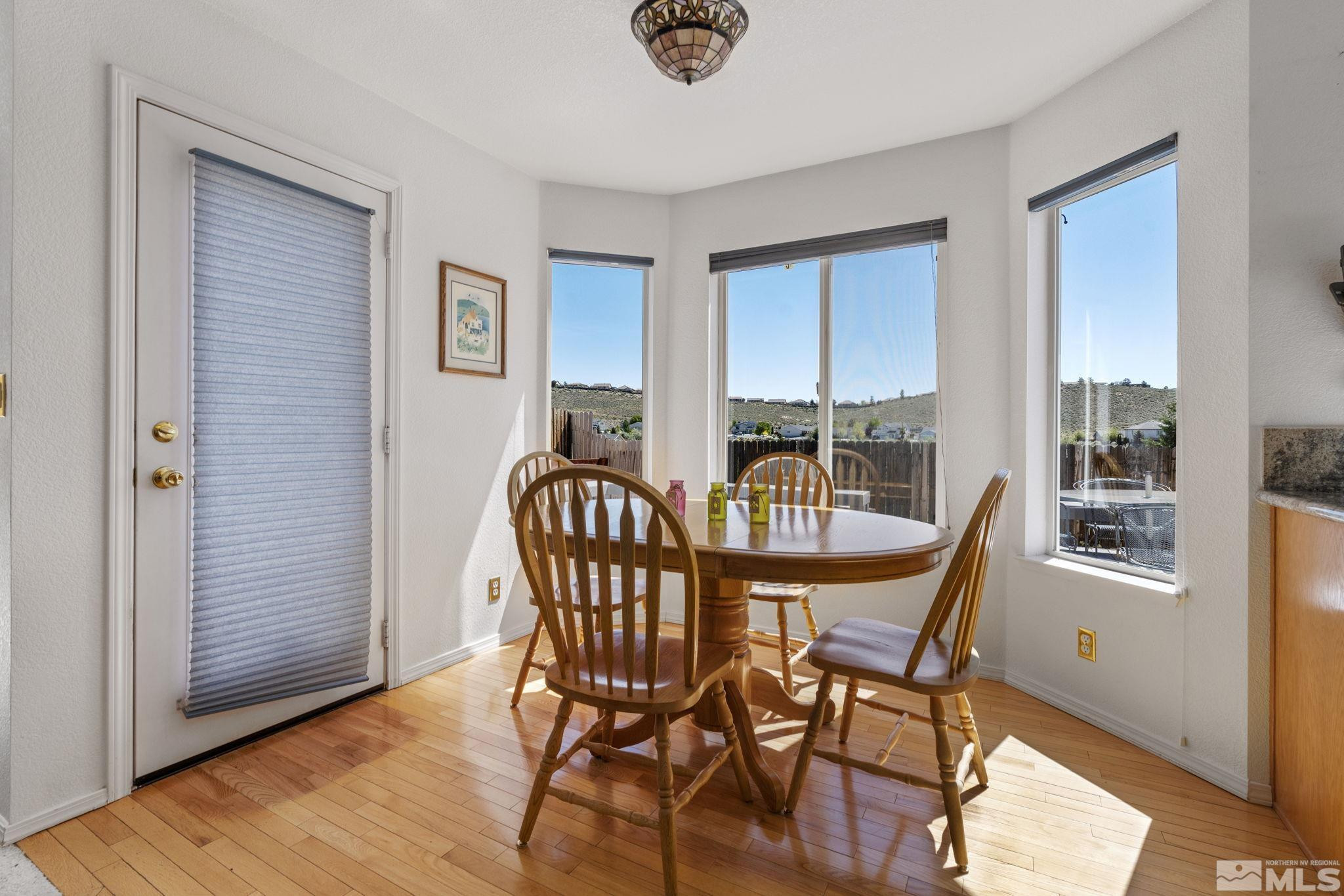 1348 Backer Way Reno, NV 89523 - Photo 18 of 40 a view of a dining room with furniture and wooden floor