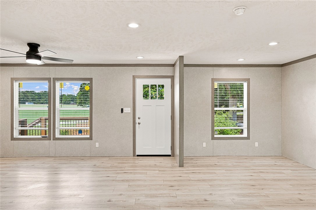 112 Purdy Road Iva, SC 29655 - Photo 10 of 33 Crisp recessed lights and light-toned wood-style flooring anchor this open entryway space.