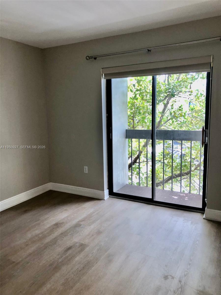 4708 Southwest 67th Avenue, Unit L23 Miami, FL 33155 - Photo 11 of 19 a view of an empty room with a large window