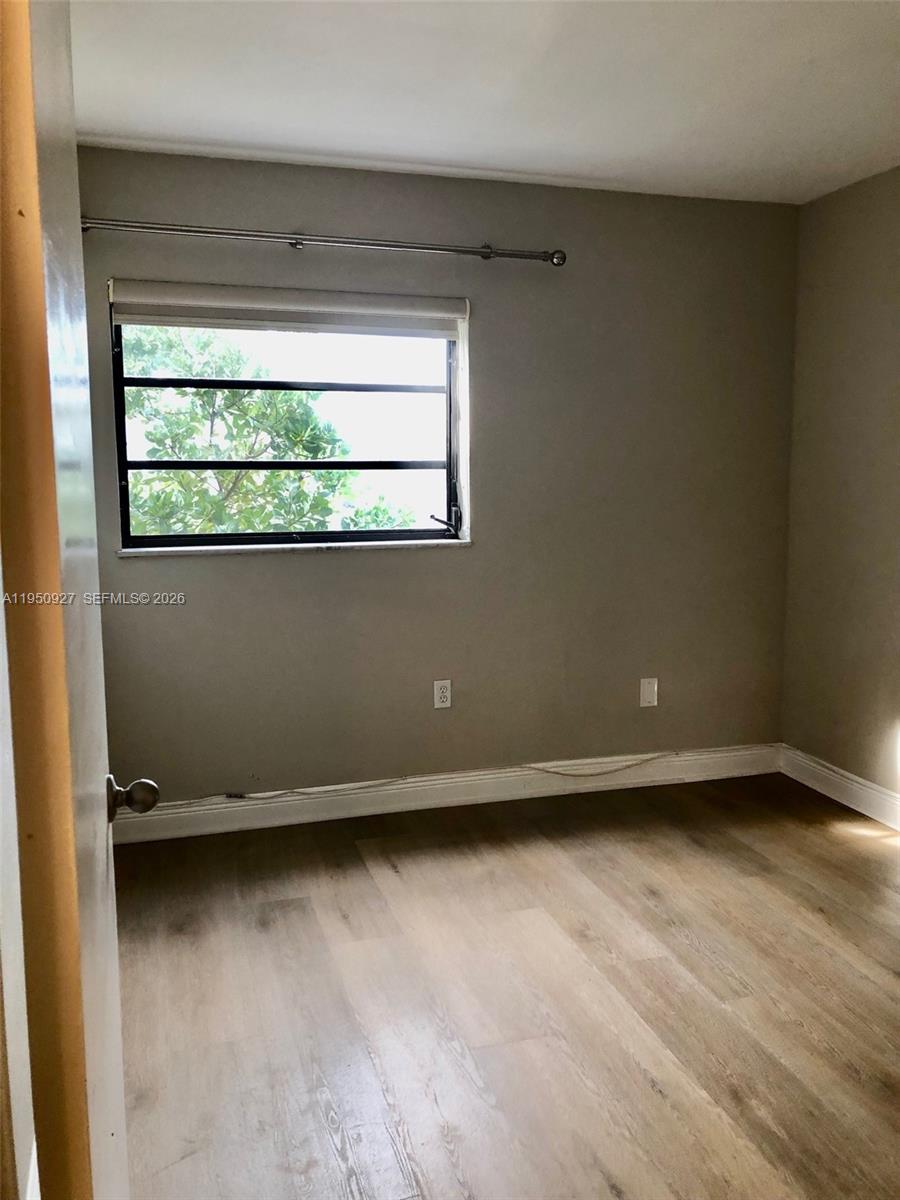 4708 Southwest 67th Avenue, Unit L23 Miami, FL 33155 - Photo 13 of 19 an empty room with a window