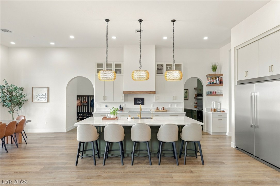 324 Wanda Road Henderson, NV 89002 - Photo 12 of 96 An open kitchen design showcases high ceilings, a grand island, and durable wood-look flooring.
