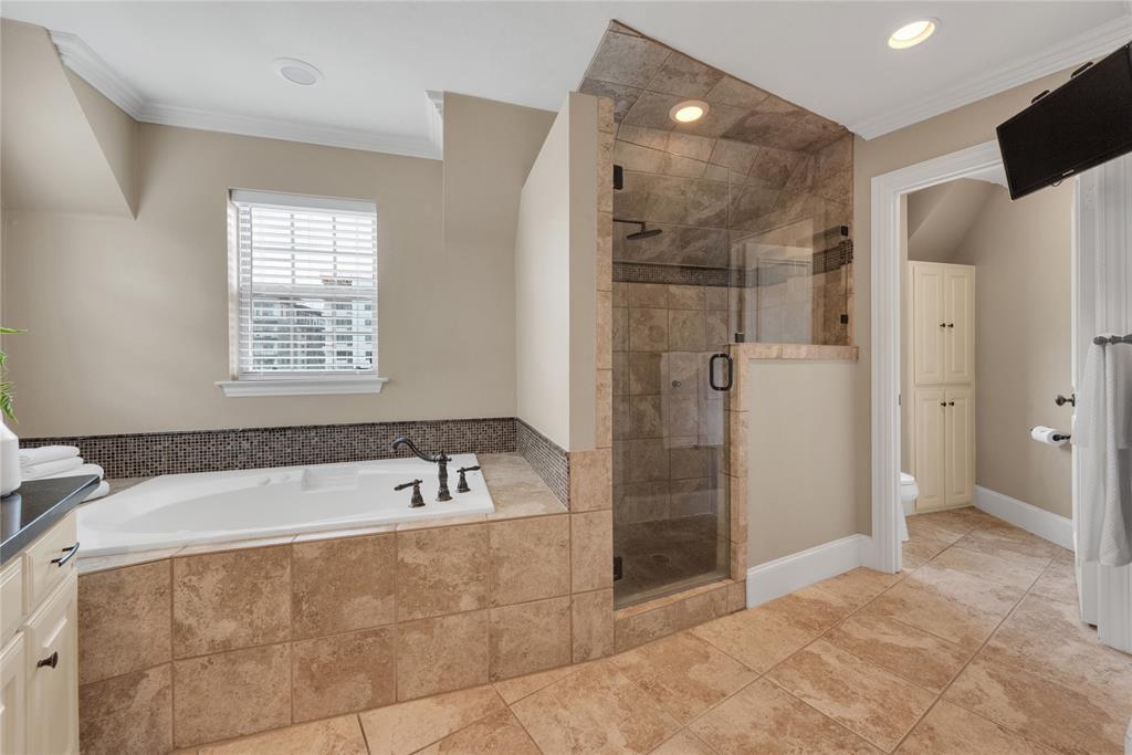 5102 Ridgedale Avenue Dallas, TX 75206 - Photo 18 of 27 Spacious bathroom featuring a built-in tub with dark bronze fixtures, a tiled surround, and a mosaic tile backsplash