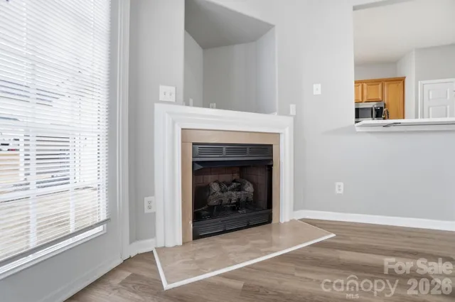a living room with a fireplace and a window