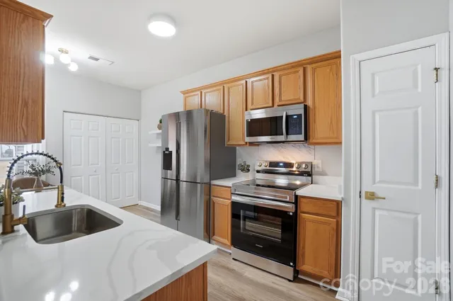 a kitchen with a sink stove and refrigerator