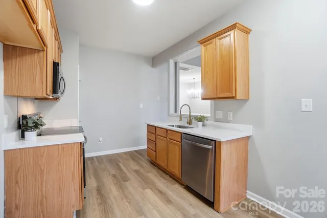 a kitchen with a sink a window and cabinets