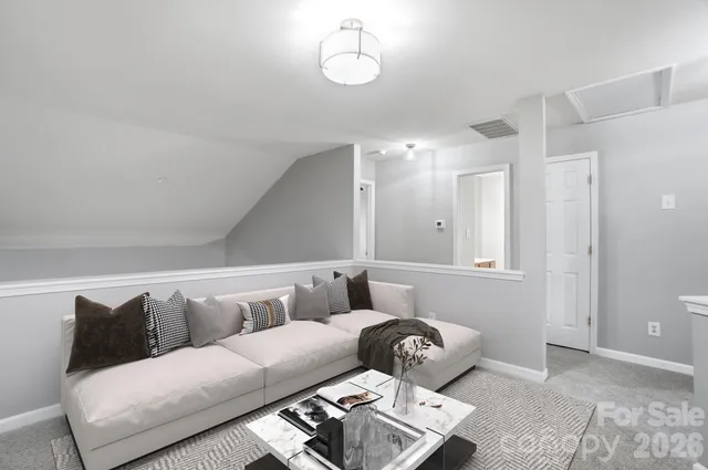 a living room with furniture and a ceiling fan