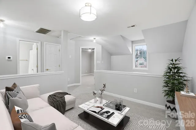 a living room with furniture and a potted plant