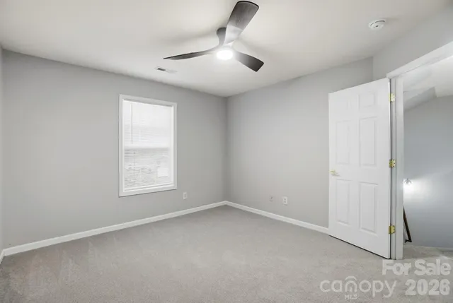 an empty room with windows and closet