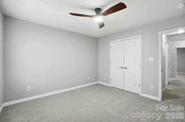 an empty room with ceiling fan