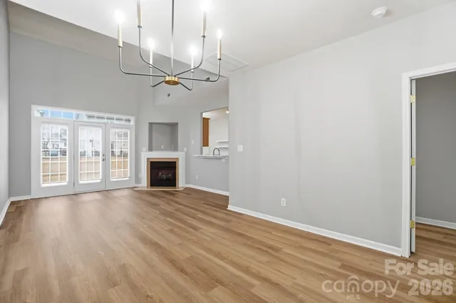 a view of an empty room with a window and fireplace