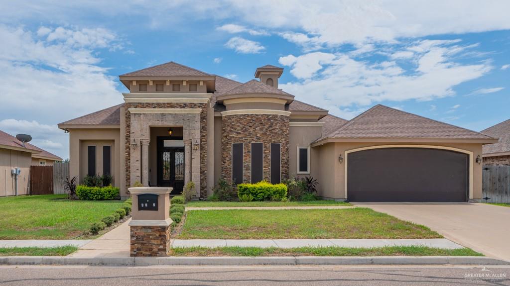 1702 East 27th Street Mission, TX 78574 - Photo 1 of 1 a front view of a house with a garden